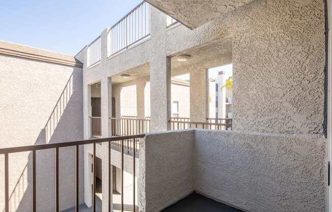 A white building with a balcony and a staircase.