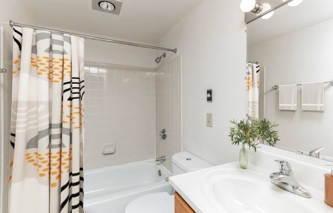 a bathroom with a shower and a sink and a bath tub