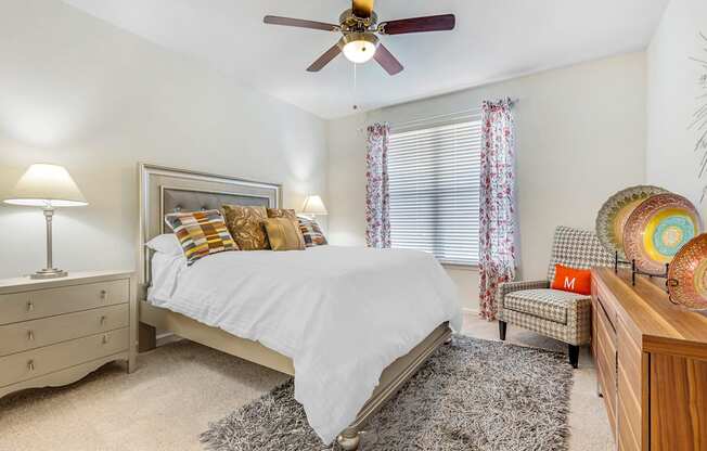 a bedroom with a bed and a ceiling fan