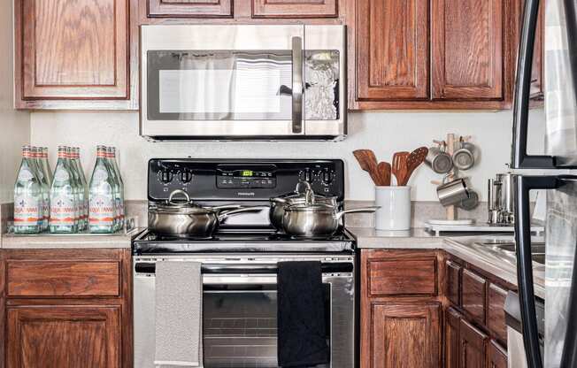 a kitchen with wooden cabinets and stainless steel appliances