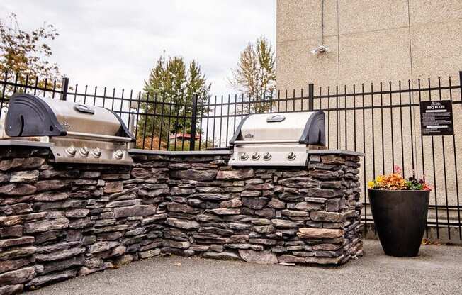 Two grills are mounted on a stone wall. at The Aviator, Washington