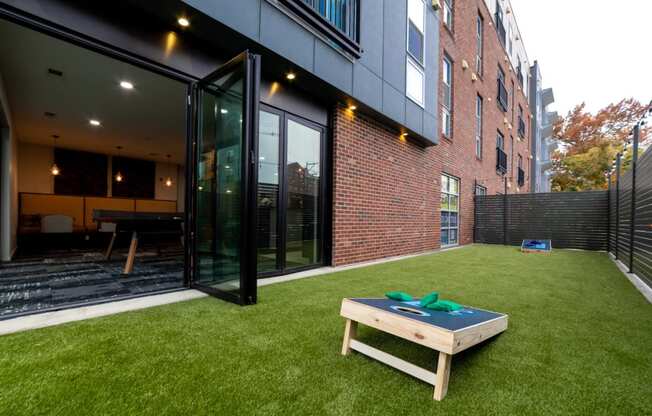 a yard with a table and a brick wall at 310 at Nulu Apartments-Student, Louisville, KY 40202