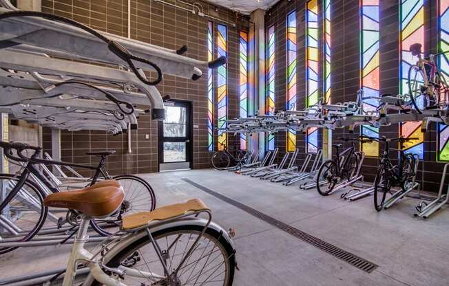 Apartments in Portland, OR - Muse Apartments Bike Storage Center With Numerous Racks and Beautiful Stained Glass Windows