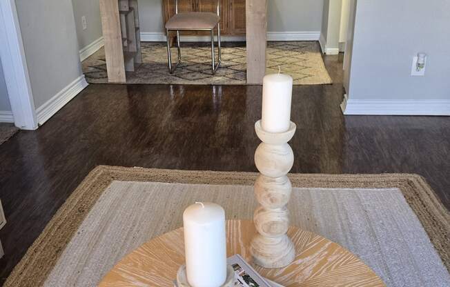 a living room with a table with two candles on it