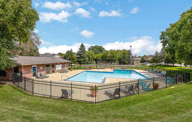 the swimming pool at our apartments with a fence around it