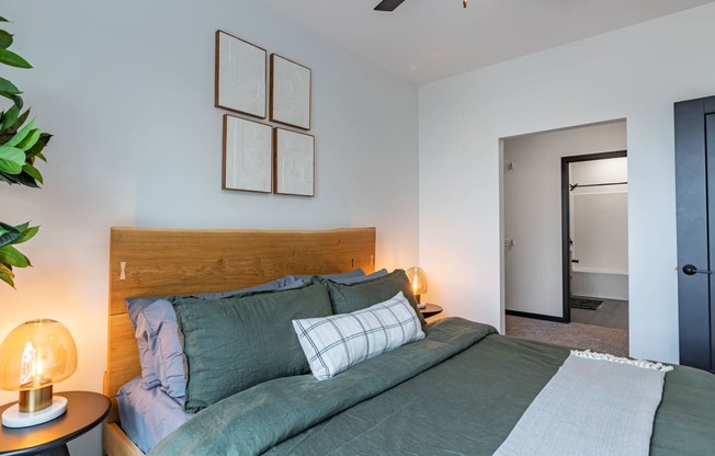 a bedroom with a bed and some pictures on the wall