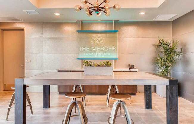 A conference room with a long table, chairs, and a chandelier.