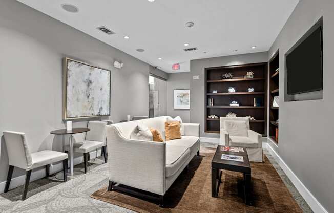 a living room with a couch and chairs and a television