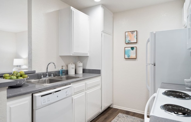 a kitchen with white appliances and a white refrigerator