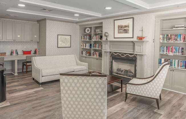 A living room with a fireplace and a bookshelf.