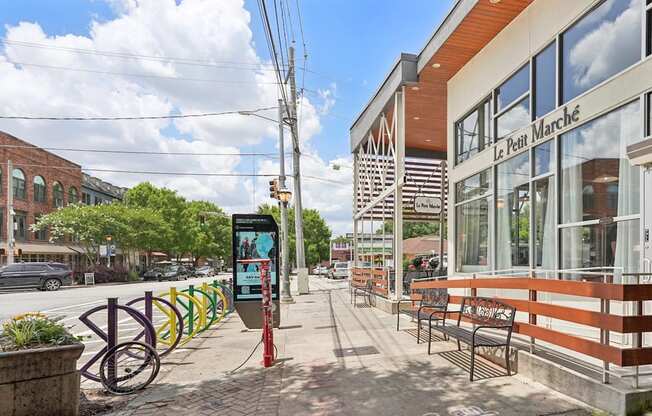 Le Petit Marché restaurant:  a street view with a bench, a bike rack