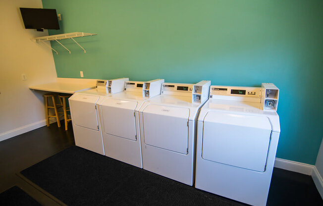 A row of washing machines in a laundromat.