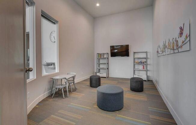 a room with a table and chairs and a clock on the wall  at Affinity 56 Apartments in West Jordan, Utah