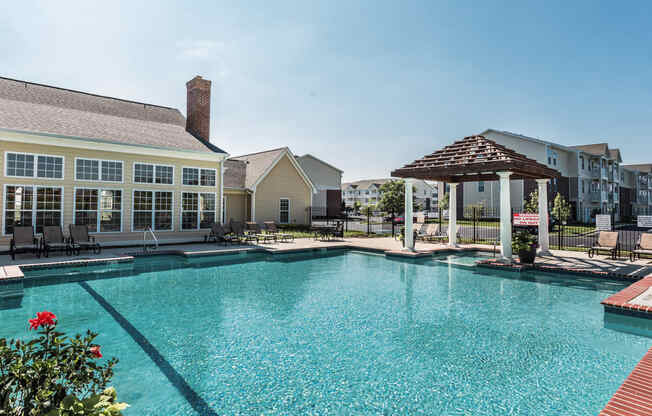 a large swimming pool with apartments in the background