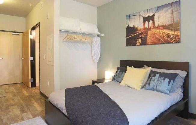 a bedroom with a bed and a painting on the wall