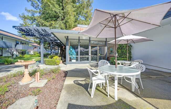 a patio with a table and chairs and an umbrella