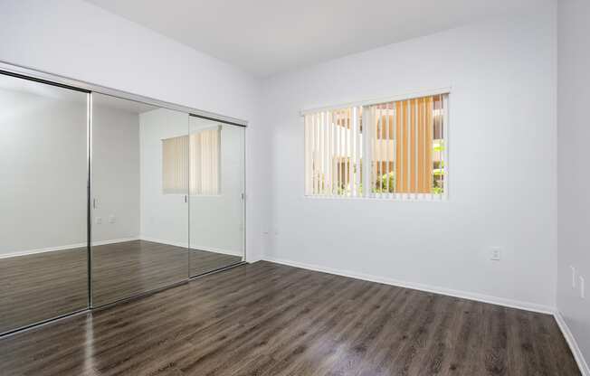 an empty room with a glass door and a window