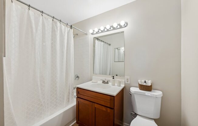 a bathroom with a sink toilet and a shower