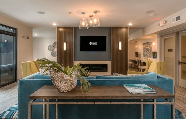 A modern living room with a blue couch and a wooden coffee table.
