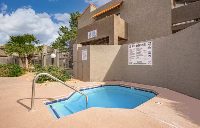 A pool in a concrete building with a sign that says "NO DIVING".
