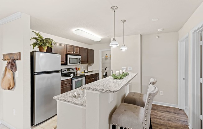 a kitchen with granite countertops and stainless steel appliances