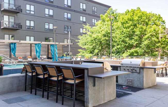 A bar with stools is set up on a patio.