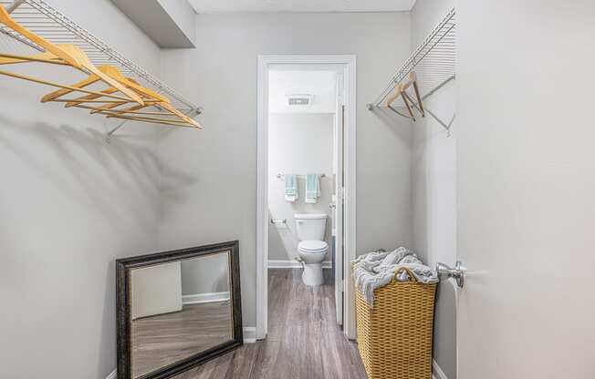 a bathroom with a toilet and a mirror in a small room