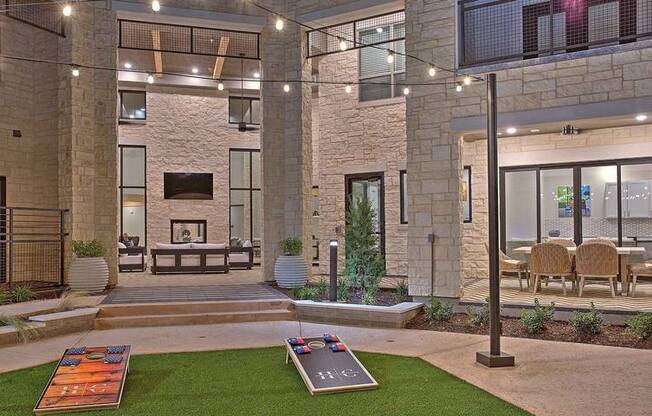 a view of a building with a courtyard with grass and a fountain at Hunters Creek Apartments, Denton, TX