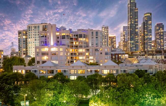 A cityscape at dusk with a mix of modern and traditional buildings.