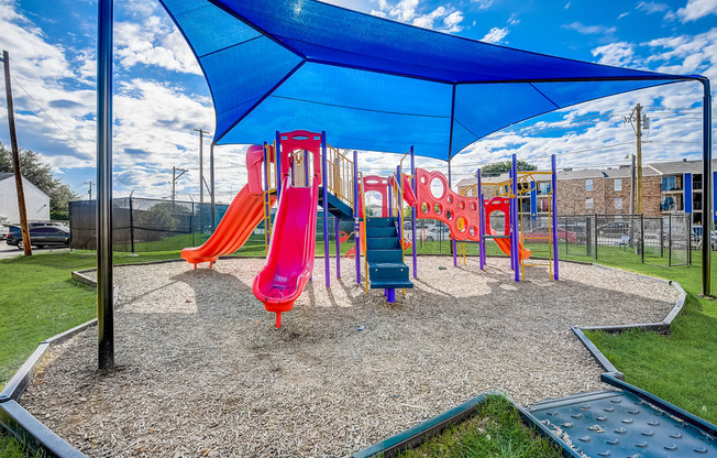 a playground with a swing set and slides