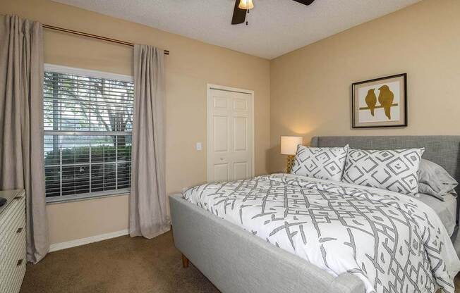 a bedroom with a bed next to a window  at Ocean Park, Florida