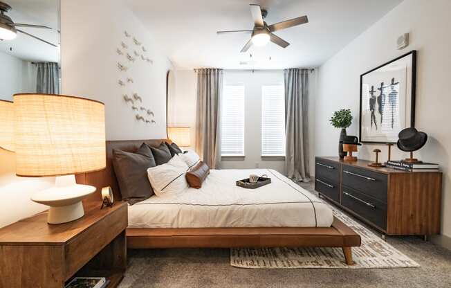 a bedroom with a bed and dresser in a 555 waverly unit