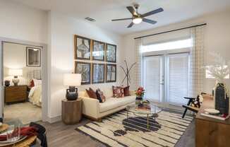 a living room with a couch and a ceiling fan