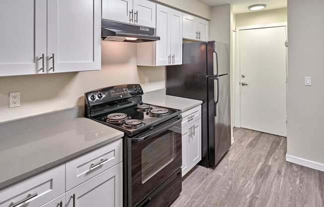 Kitchen with appliances at Arterra Apartments, Kent, 98030