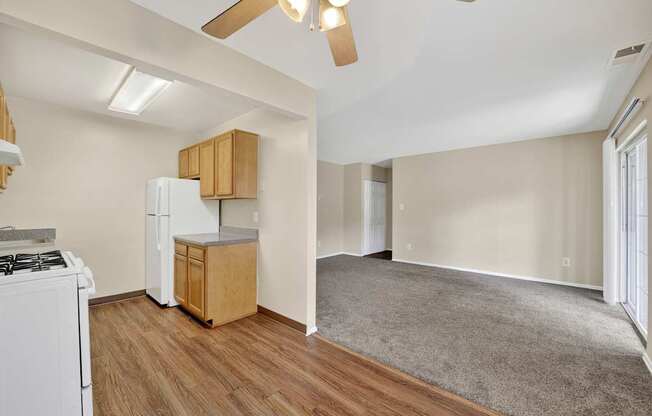 A kitchen with a white stove and wooden cabinets.