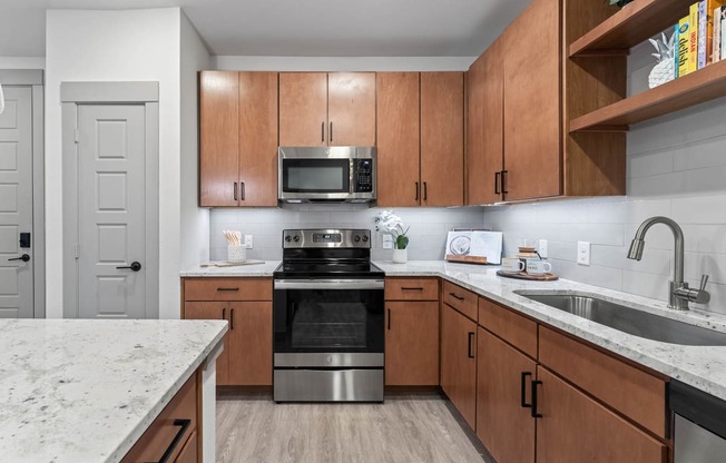 a kitchen with wooden cabinets and stainless steel appliances