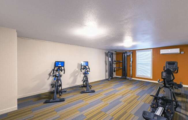 Fitness center with one window, stationary bikes, cable machine and rowing machine..at Park View Apartments, Wenatchee