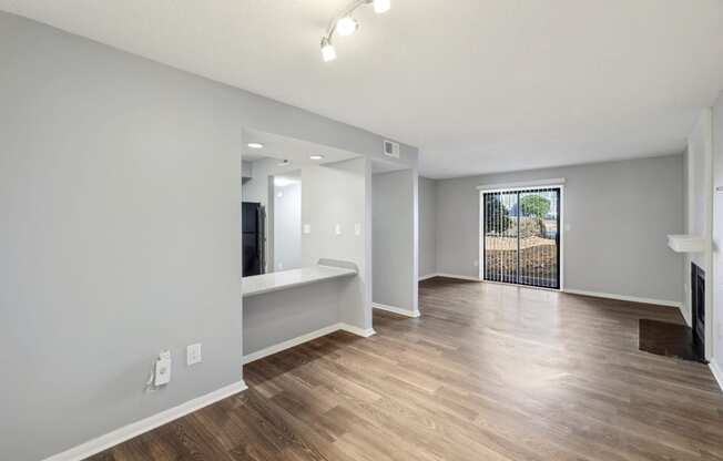 Living room and dining room of an apartment with wood flooring and a balcony  at Governors House, Alabama