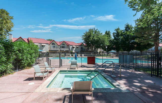 Swimming Pool and Spa with lounge chairs and area is gated