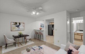 a living room and dining room with a table and a ceiling fanat Millcreek Woods Apartments, Olathe