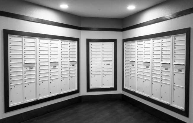 A room with two sets of white lockers.