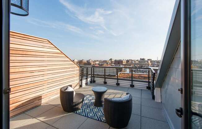 a roof terrace with a view of the city