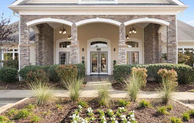 A house with a front yard and a white door.