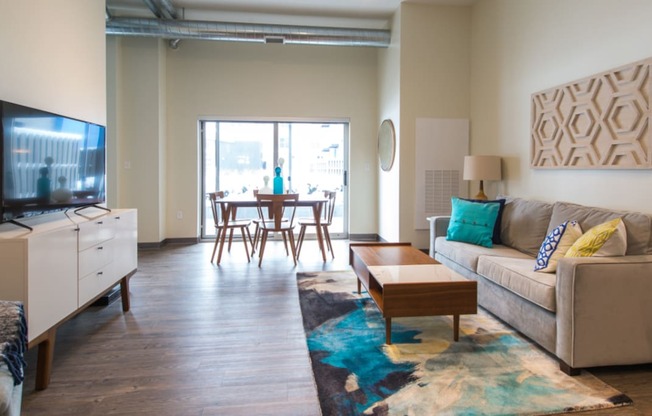 a living room with a couch a coffee table and a tv