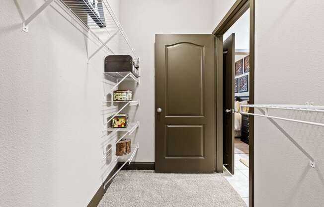closet with brown door and white wire shelves