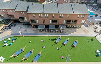 an aerial view of the courtyard with lounge chairs and umbrellas
