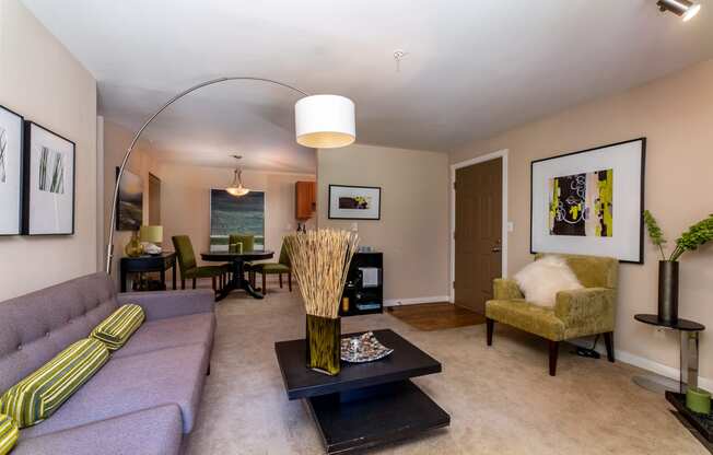 a living room with a purple couch and a yellow chair