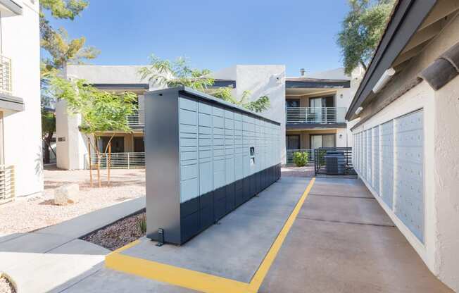 a parking lot with a blue garage door and a white building in the background