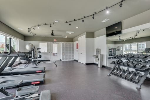 24/7 fitness center with treadmills and free weights at MacArthur Park, Augusta, GA
