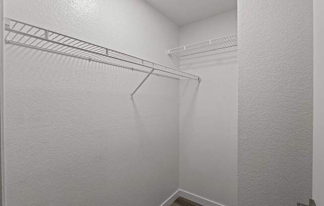 A white closet with a metal rack.